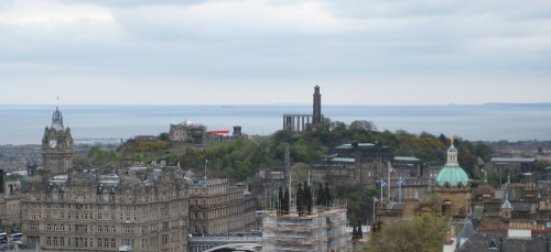 An overhead view of Old Town Edinburgh, with Calton Hill in the distance.